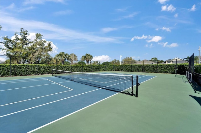 view of tennis court with fence