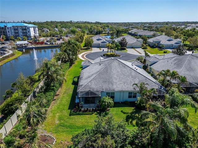 drone / aerial view with a residential view and a water view