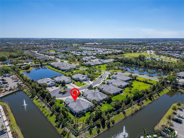 bird's eye view featuring a residential view and a water view