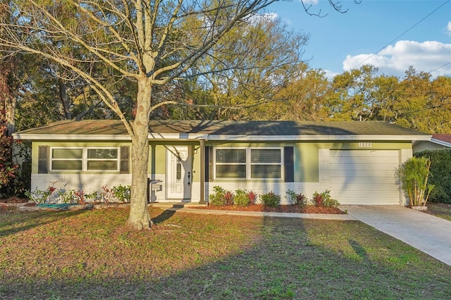 single story home featuring stucco siding, an attached garage, concrete driveway, and a front lawn