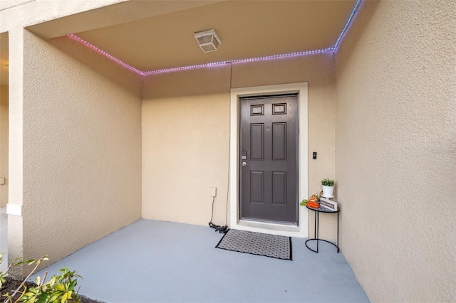 property entrance featuring stucco siding