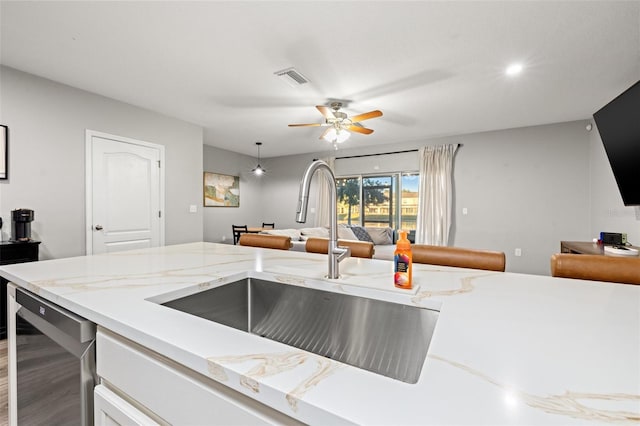 kitchen featuring visible vents, ceiling fan, open floor plan, dishwasher, and a sink