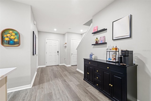 hallway with recessed lighting, baseboards, and light wood-style flooring