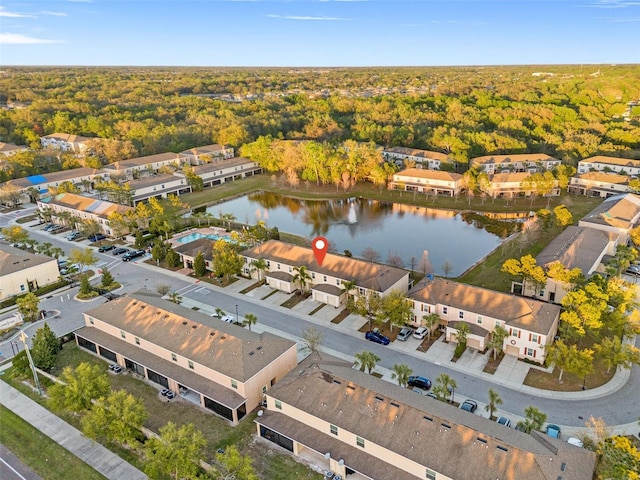 aerial view with a residential view, a water view, and a wooded view