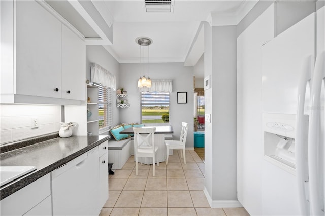 kitchen featuring visible vents, dark countertops, breakfast area, white appliances, and white cabinets