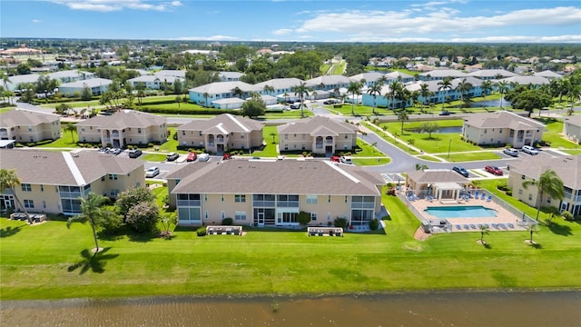 drone / aerial view featuring a residential view and a water view