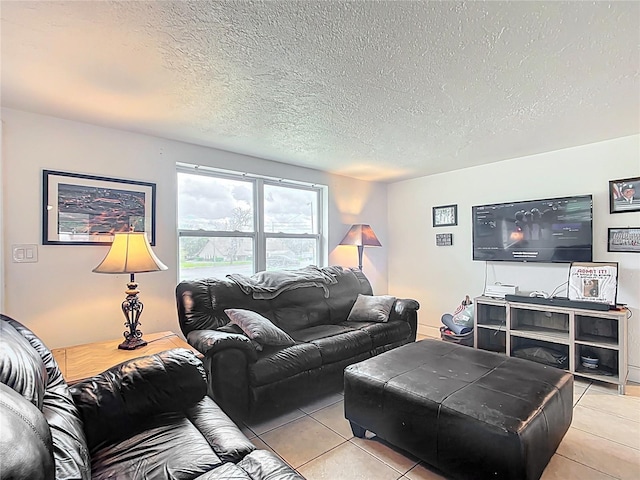 living area with a textured ceiling and light tile patterned flooring