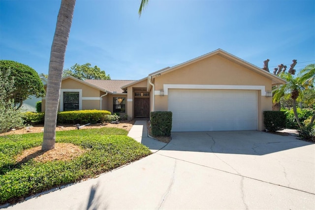 view of front of house featuring stucco siding, driveway, and an attached garage