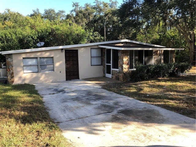 view of front of property with stucco siding and stone siding