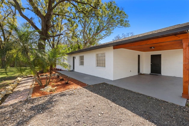 exterior space featuring a carport and gravel driveway