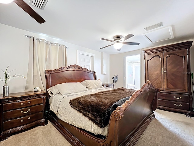 bedroom featuring attic access, a ceiling fan, visible vents, and light carpet