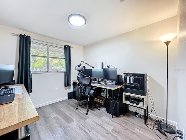 office area featuring baseboards and wood finished floors