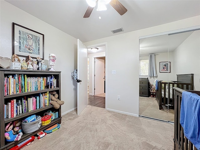 interior space with baseboards, visible vents, a ceiling fan, and carpet