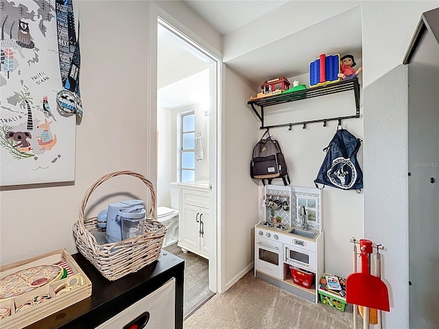 mudroom with light colored carpet and baseboards