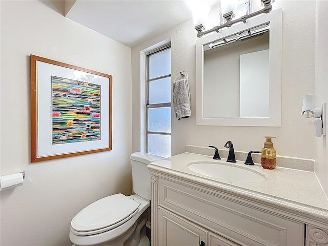 bathroom featuring toilet and vanity