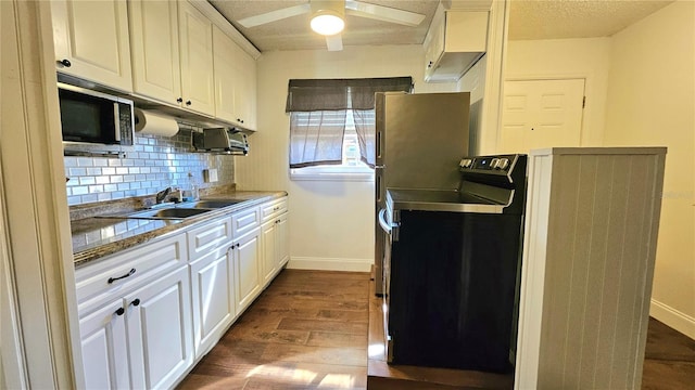 kitchen with tasteful backsplash, dark wood-type flooring, white cabinets, stainless steel appliances, and a sink