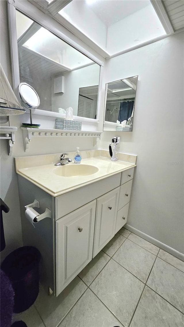 bathroom featuring tile patterned floors, vanity, and baseboards