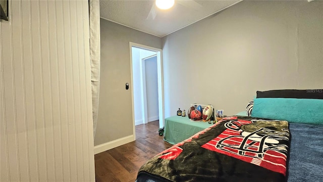 bedroom with baseboards, dark wood-style flooring, and ceiling fan