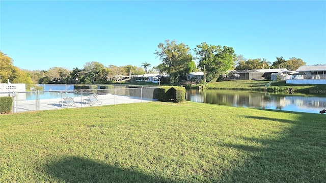 view of yard featuring fence and a water view