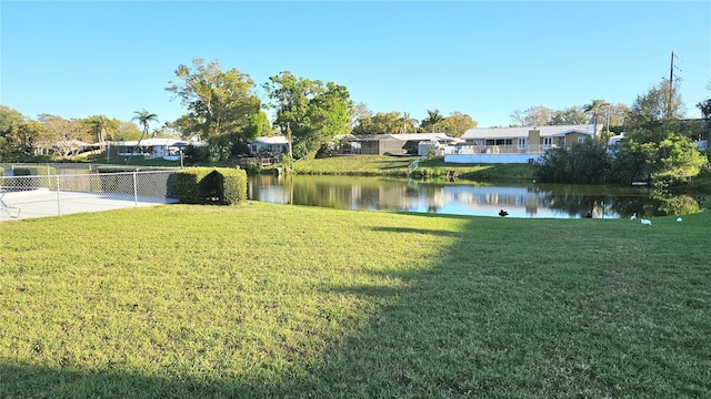 view of yard featuring fence and a water view