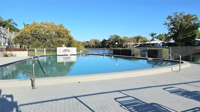 community pool featuring a patio and fence