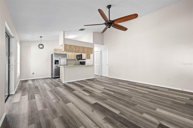 unfurnished living room featuring visible vents, baseboards, ceiling fan, dark wood finished floors, and high vaulted ceiling