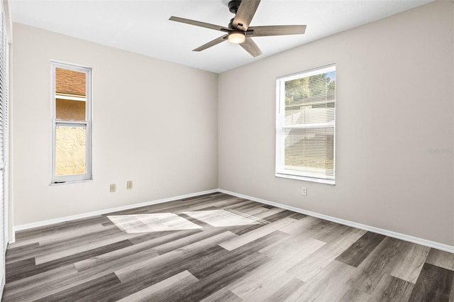 unfurnished room with wood finished floors, baseboards, and ceiling fan