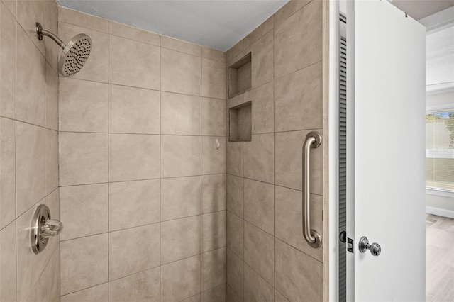 bathroom with a tile shower