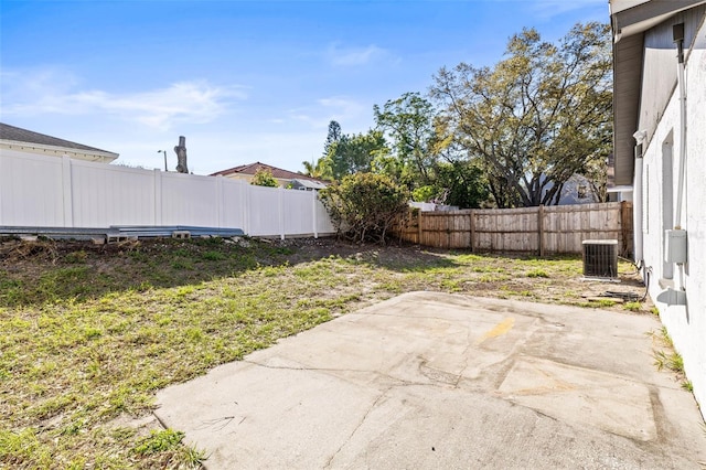 view of yard featuring central air condition unit, a patio, and a fenced backyard