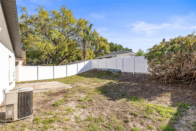 view of yard featuring cooling unit, a patio, and a fenced backyard