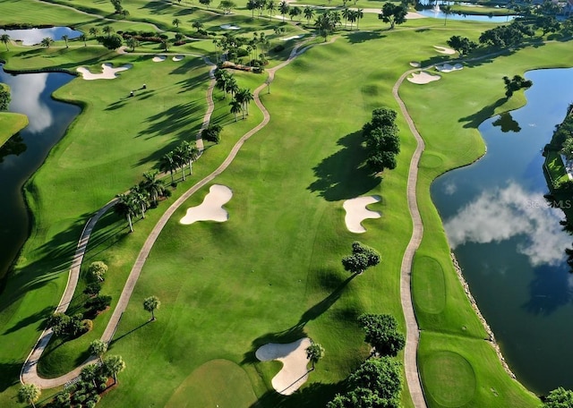 drone / aerial view featuring view of golf course and a water view