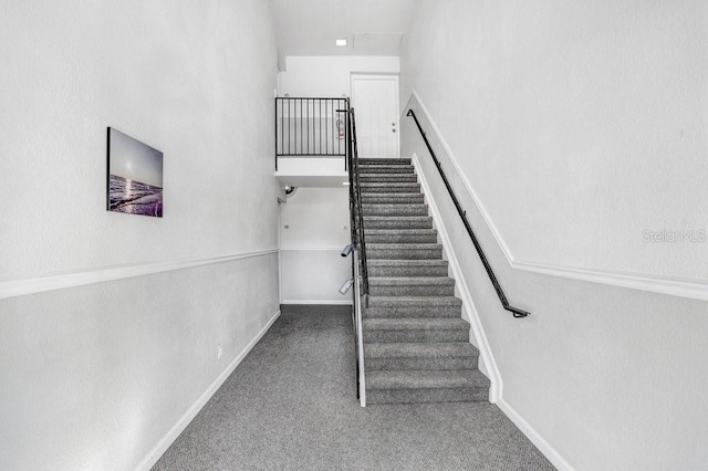 stairs featuring carpet and baseboards