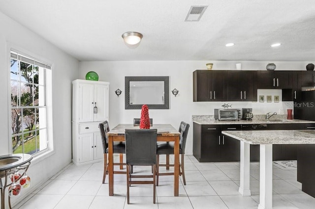 dining room with a toaster, visible vents, recessed lighting, and light tile patterned floors