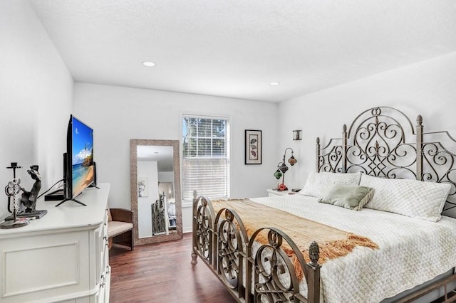 bedroom featuring recessed lighting and dark wood-style floors