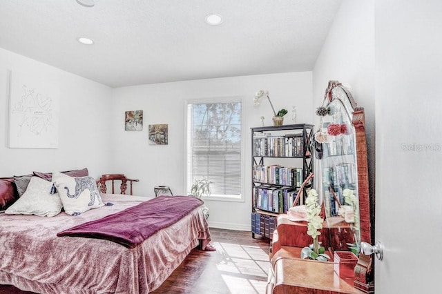 bedroom with recessed lighting, baseboards, and wood finished floors