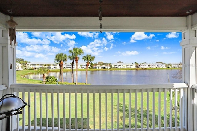 unfurnished sunroom with a water view