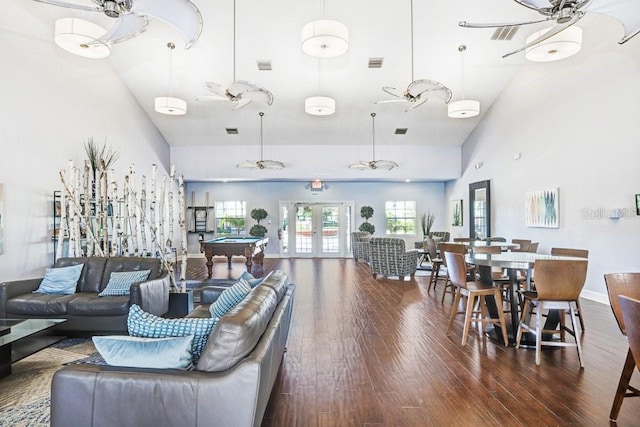 living area with french doors, visible vents, wood finished floors, and a ceiling fan