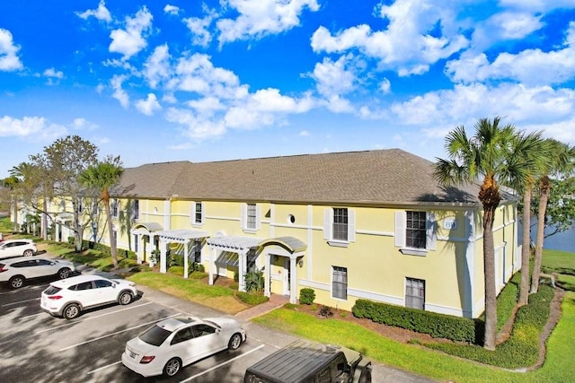 view of property with a residential view and uncovered parking