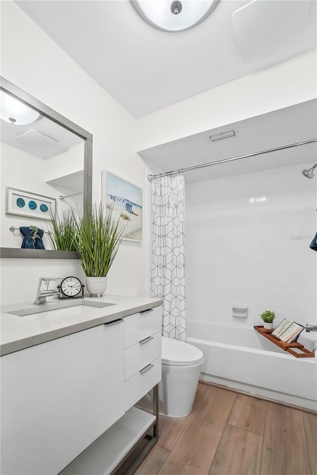 full bath featuring shower / bath combination with curtain, toilet, vanity, and wood finished floors