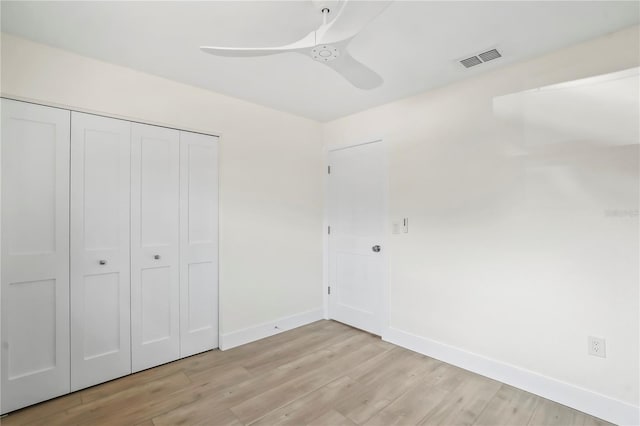 unfurnished bedroom featuring a closet, visible vents, baseboards, and light wood-style floors