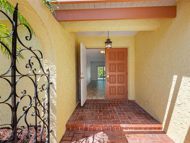 entrance to property featuring stucco siding