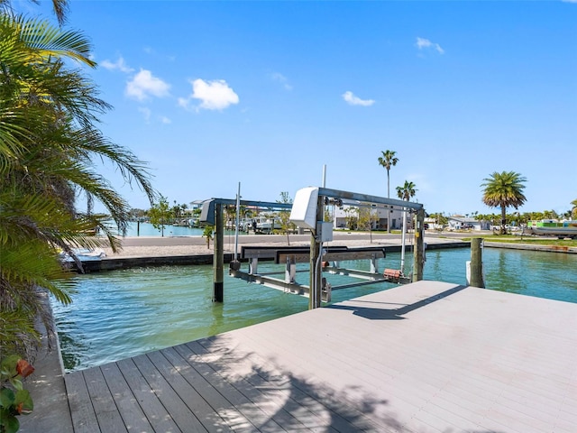 dock area with a water view and boat lift