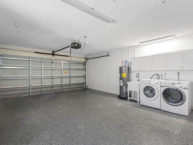 garage featuring a sink, a garage door opener, water heater, and washing machine and clothes dryer