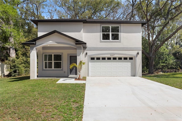 view of front of home featuring a front lawn, a garage, driveway, and stucco siding