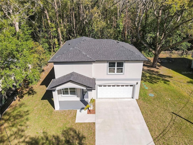 view of front of home featuring a garage, concrete driveway, a front lawn, stucco siding, and a shingled roof