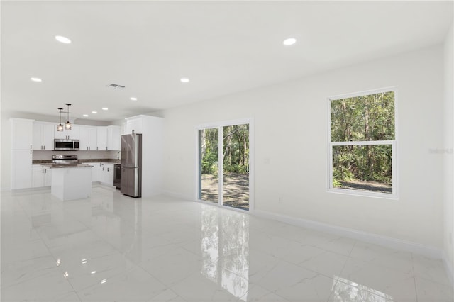 interior space with baseboards, marble finish floor, visible vents, and recessed lighting