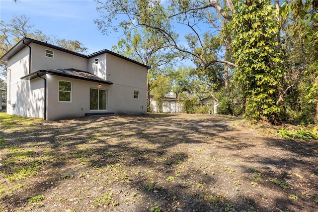 back of house featuring stucco siding