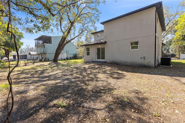 rear view of house featuring cooling unit