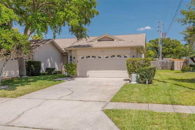 single story home featuring a front lawn, driveway, a garage, and stucco siding