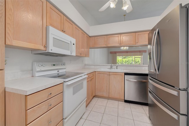 kitchen featuring a sink, appliances with stainless steel finishes, and light brown cabinets